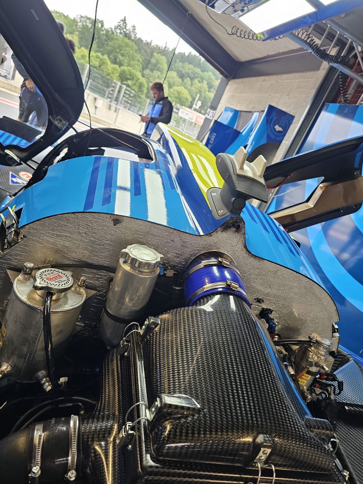 Close-up of a race car engine bay during a service